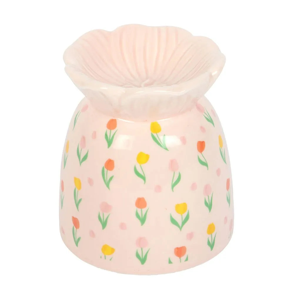 Pink ceramic oil burner with floral pattern on a white background