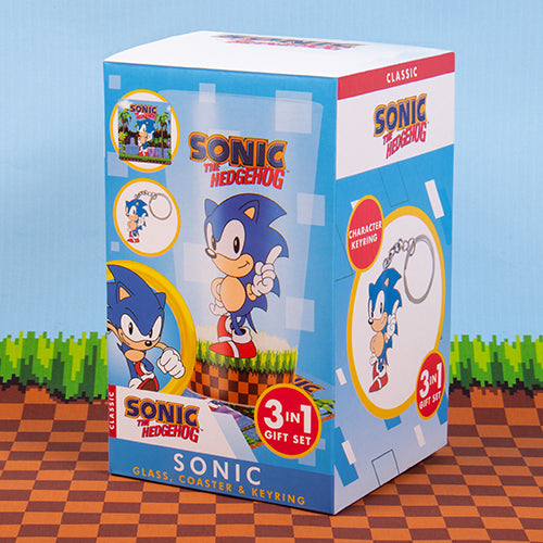 A set including a glass with Sonic the Hedgehog character design, a cork coaster with the same character, and a metal keyring featuring the hedgehog in its gift packaging