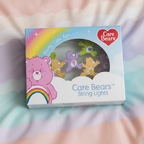 Care Bears string lights packaging on a colorful fabric background