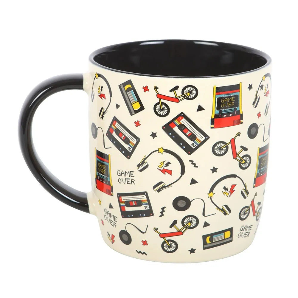 Mug with retro-themed design featuring cassette tapes, bicycles, and 'Game Over' signs on a white background.