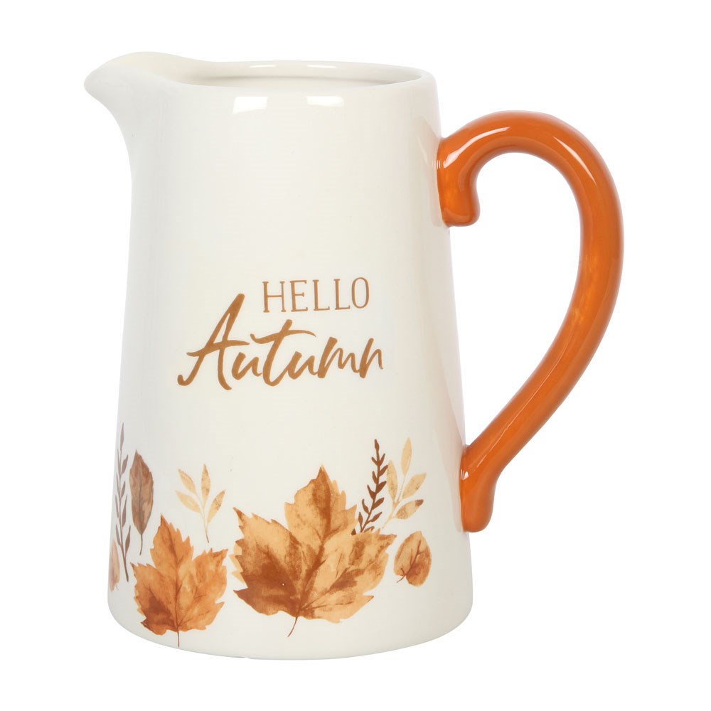 White pitcher with orange handle featuring 'Hello Autumn' text and leaf designs on a white background