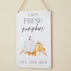 A metal wall sign with hanging Jute. Features farm fresh pumpkin text with illustrations