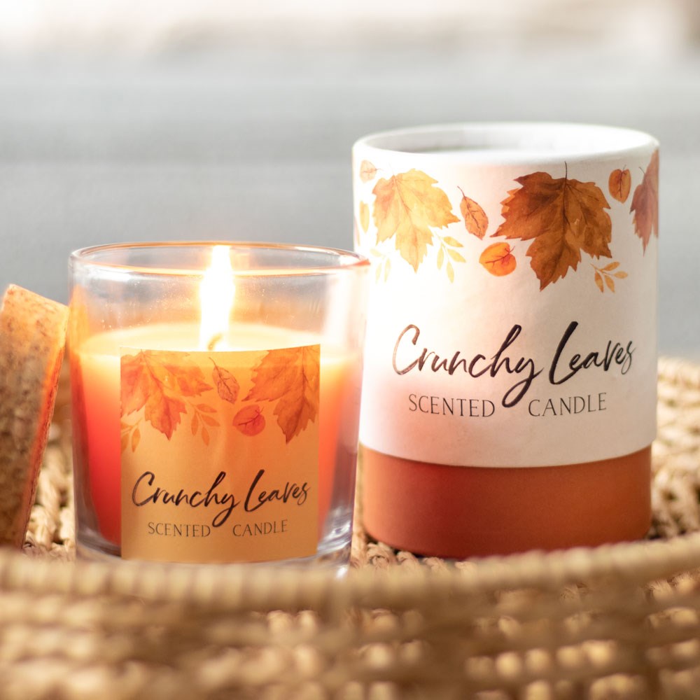 Scented candle labeled 'Crunchy Leaves' with a wicker basket background