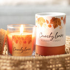 Scented candle labeled 'Crunchy Leaves' with a wicker basket background