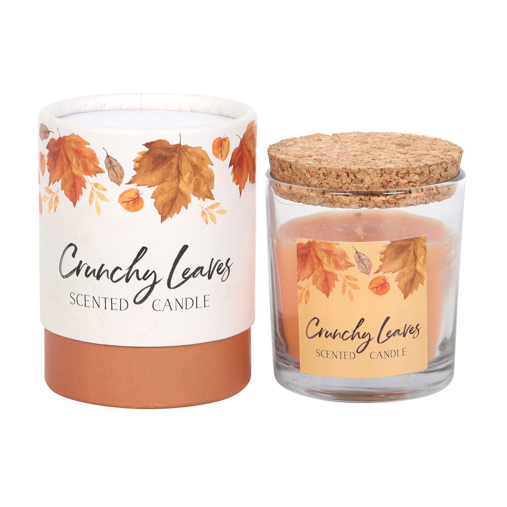 'Crunchy Leaves' scented candle with cork lid next to packaging box