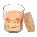 Scented candle labeled 'Crunchy Leaves' with a cork lid on a white background