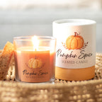 Pumpkin spice scented candle next to packaging box on a woven surface with a blurred background