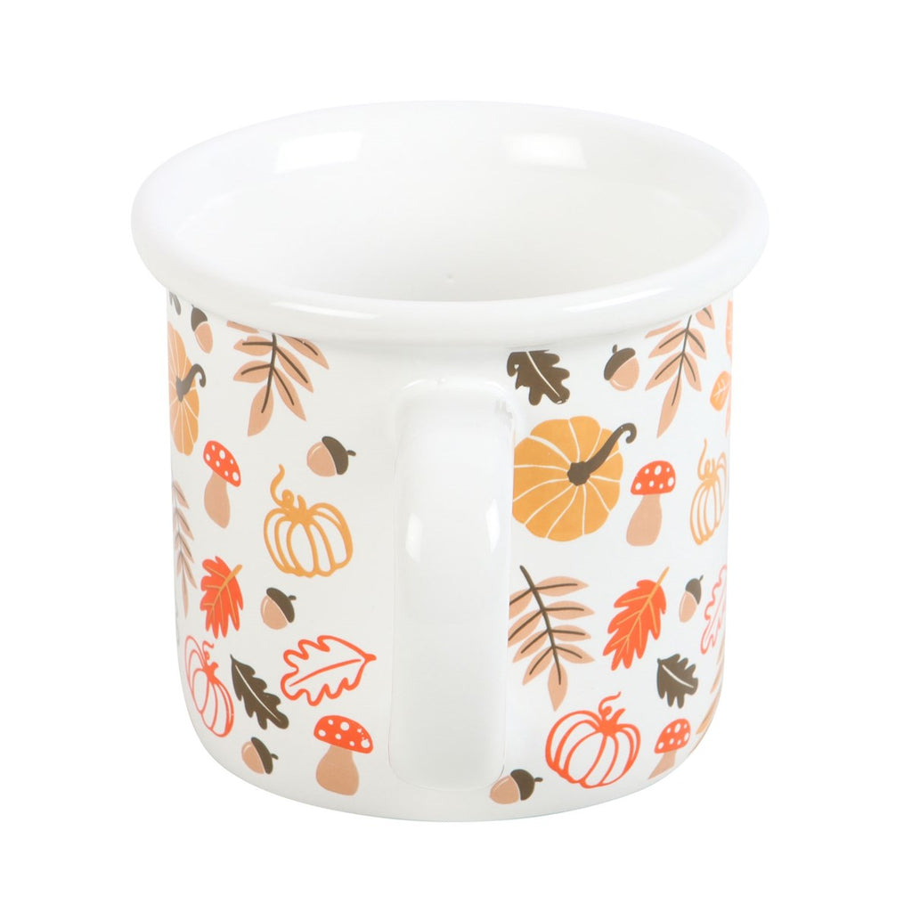 White mug with autumn-themed pattern on a white background