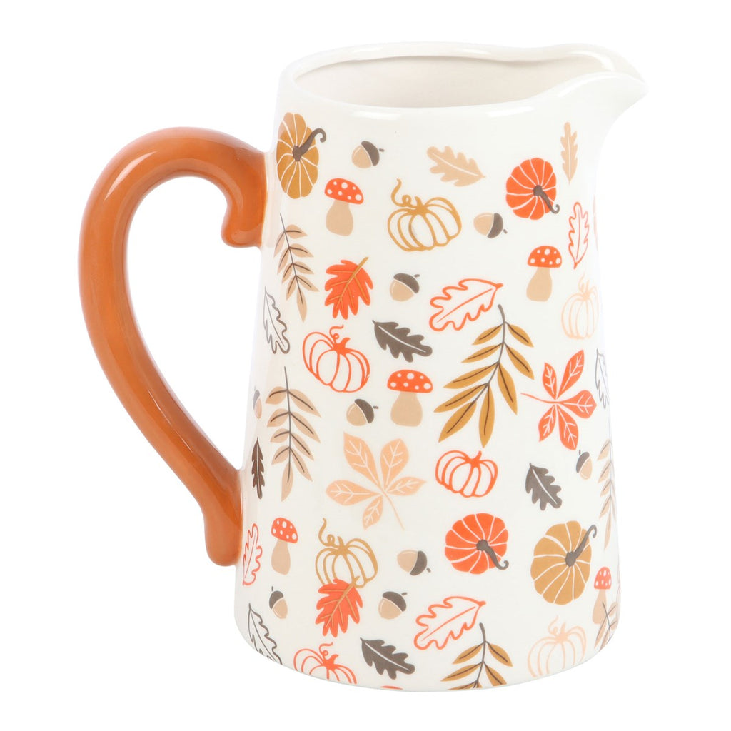 Ceramic pitcher vase with autumn-themed design on a white background