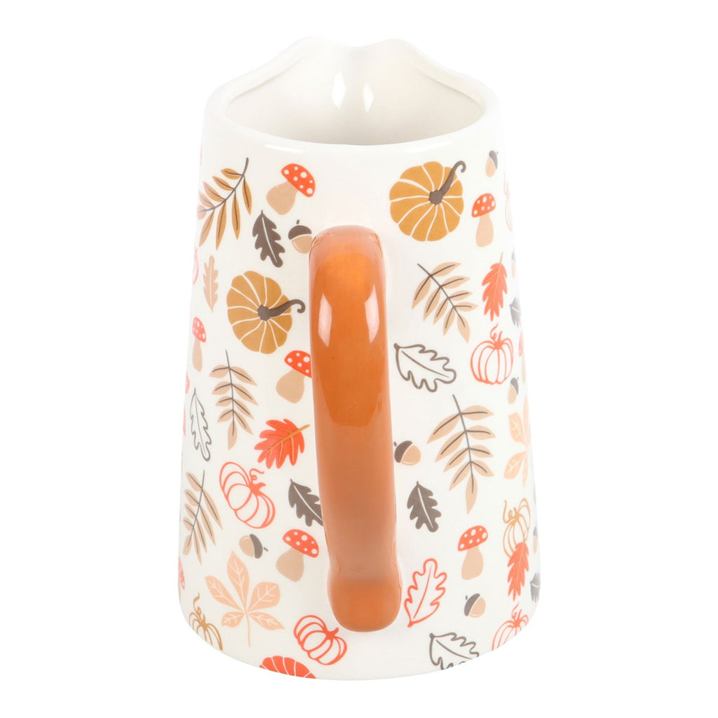 jug vase with autumn-themed design featuring pumpkins and leaves on a white background