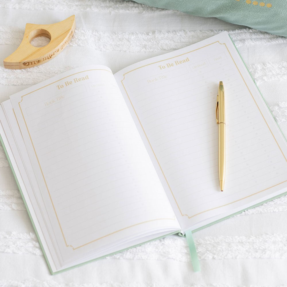 inside view of the reading journal pages showing a 'to be read' list with gold pen