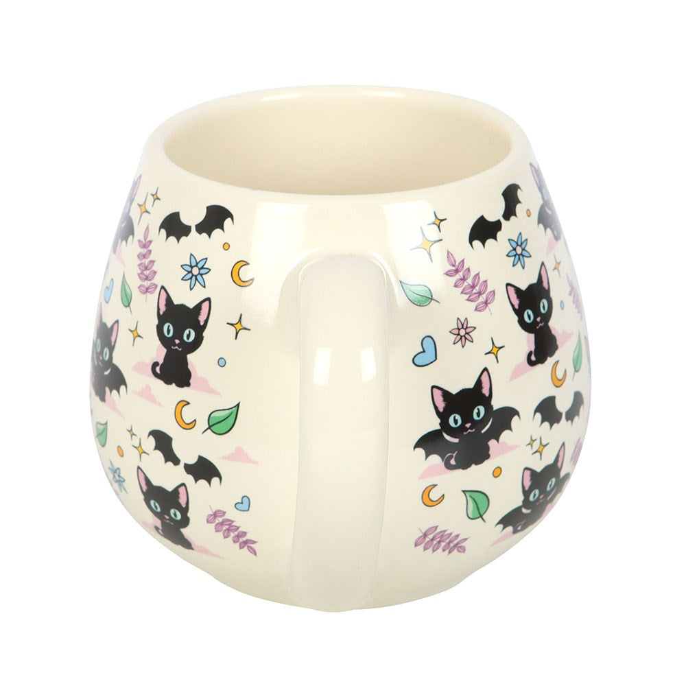 Ceramic mug with black cat illustrations on a white background
