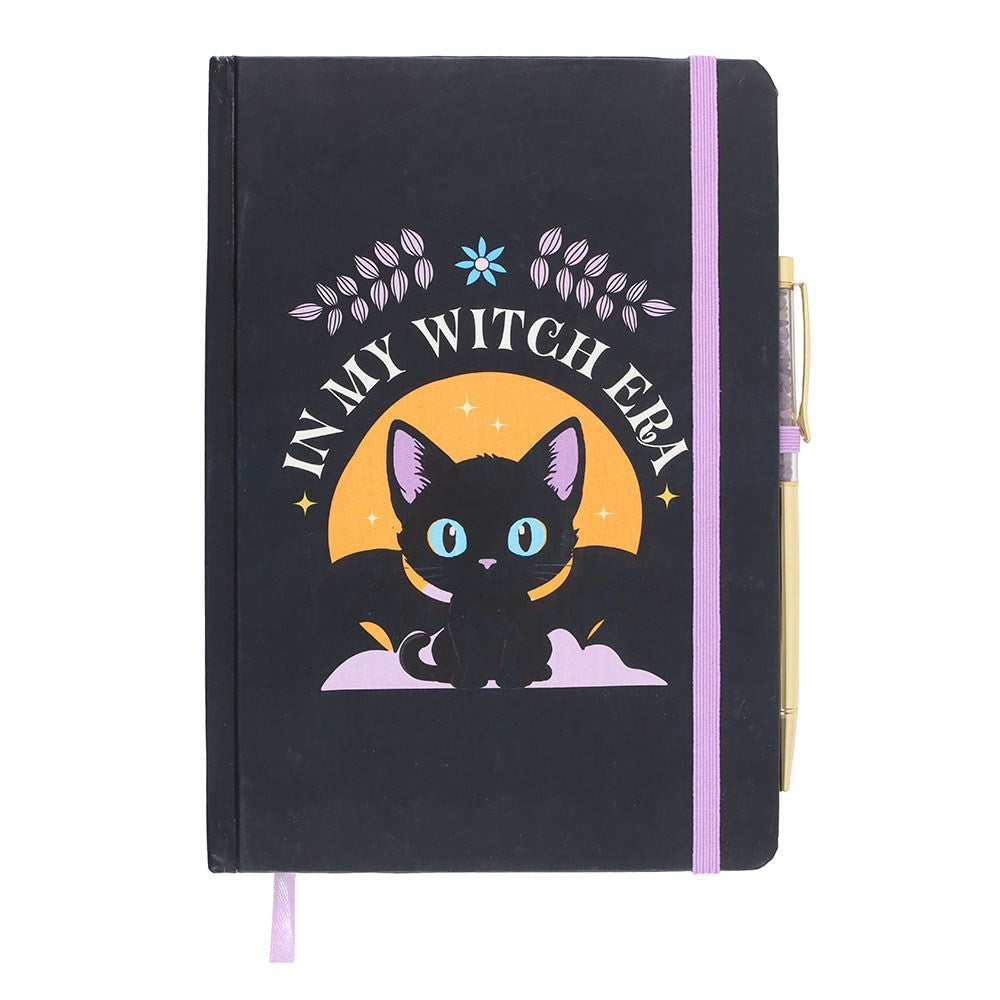 Black notebook with a cat illustration and 'In My Witch Era' text and pen on a white background