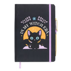 Black notebook with a cat illustration and 'In My Witch Era' text and pen on a white background