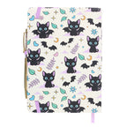 Notebook with black cat and bat pattern on a white background