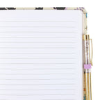 Notebook with bat cat design on the cover and a pen.