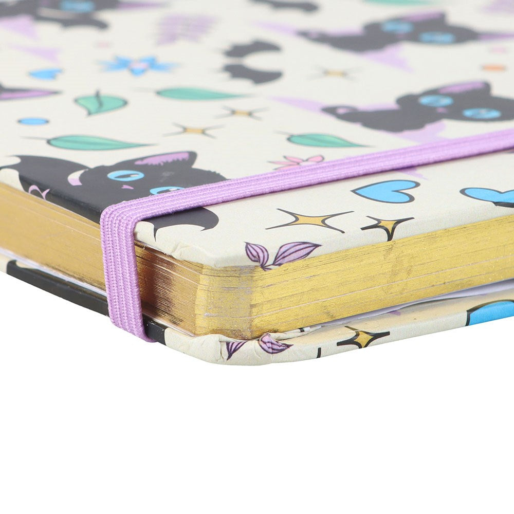 Notebook with a colourful cat pattern on the cover and gold detailed pages