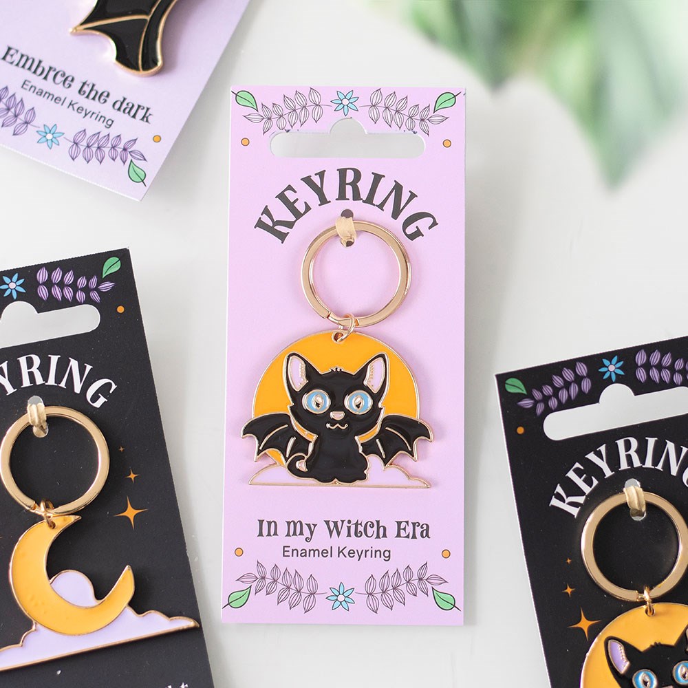 a black cat design Keyring packaging with on a white background