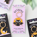 a black cat design Keyring packaging with on a white background