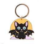 Keychain with a black bat cat design on a yellow background
