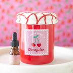 oil burner Jar of cherry jam with a dropper bottle on a pink floral background