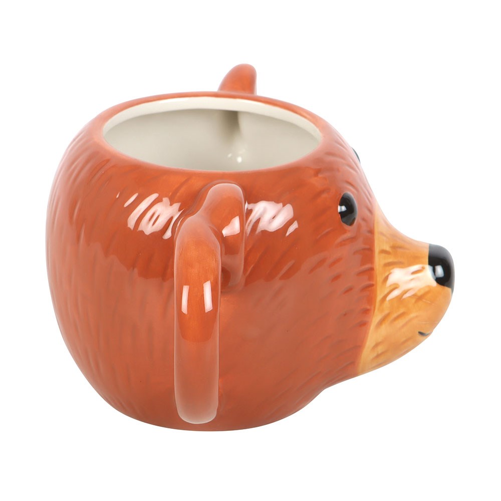 Ceramic mug shaped like a bear face on a white background