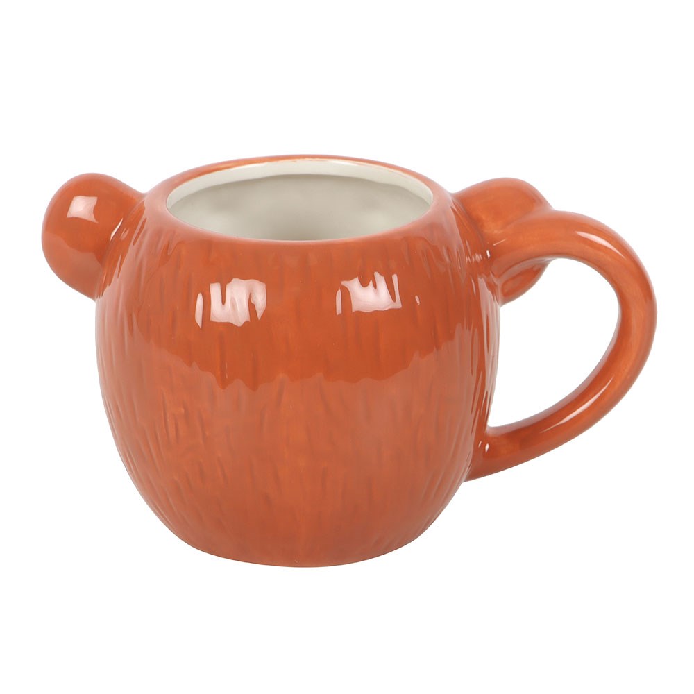 Bear shaped ceramic mug with a handle on a white background
