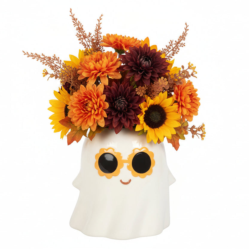 Decorative ghost vase with floral arrangement on a white background