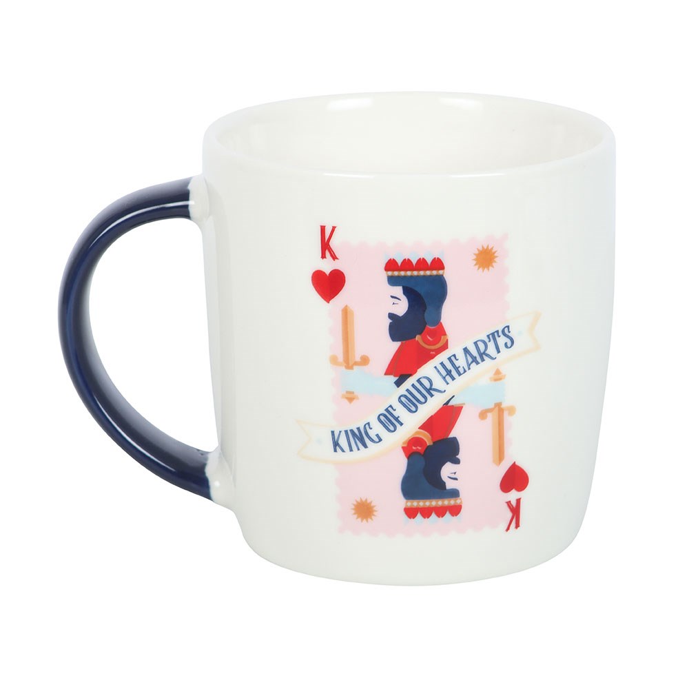 White mug with a colorful graphic of a king and text 'King of Our Hearts' on a white background