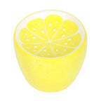 Yellow ceramic oil burner shaped like a lemon sliced on a white background