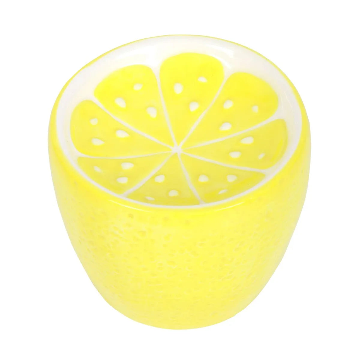 Yellow ceramic oil burner shaped like a lemon sliced on a white background