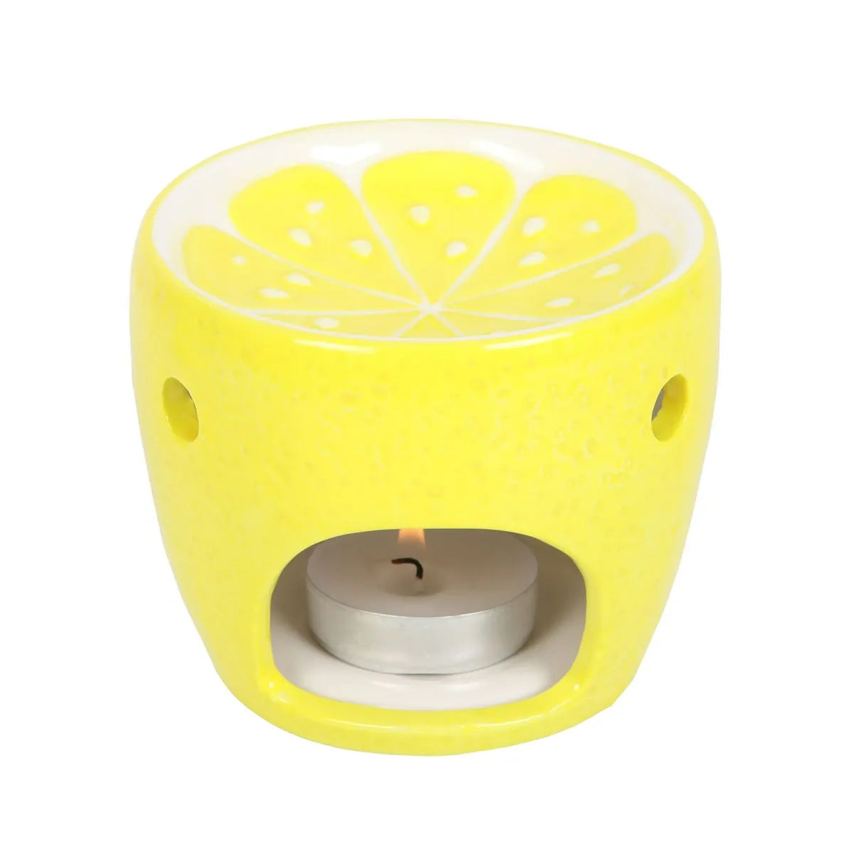 Yellow lemon-shaped oil burner with a lit tealight on a white background