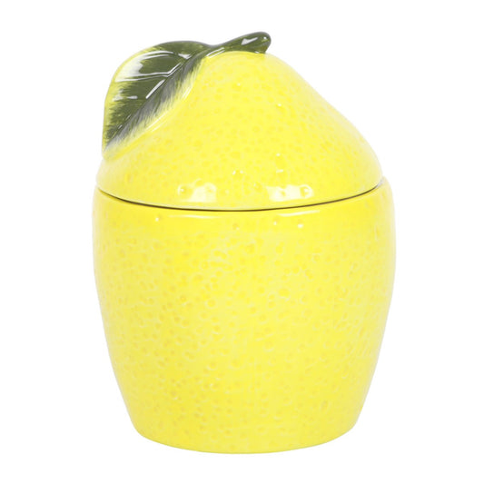 Yellow lemon-shaped oil burner with a lid on a white background