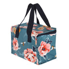 Floral and bee patterned cooler bag with navy handles on a white background