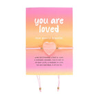 Rose quartz bracelet with 'you are loved' message on a pink and orange gradient card