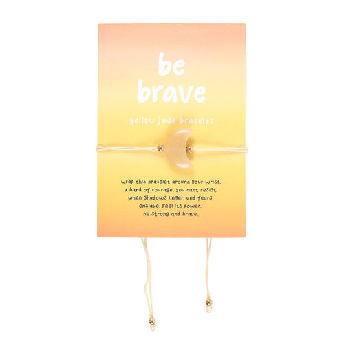Yellow jade bracelet on an orange card with 'be brave' text