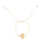 Gold bracelet with a crescent moon on a white background