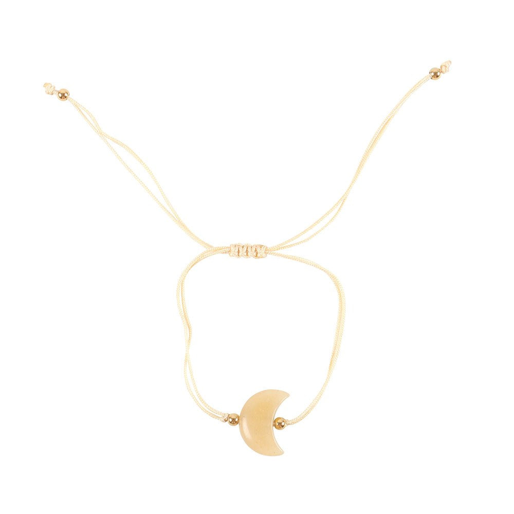 Gold bracelet with a crescent moon on a white background