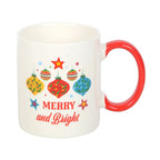 White mug with red handle featuring Christmas-themed design and 'Merry and Bright' text on a white background.