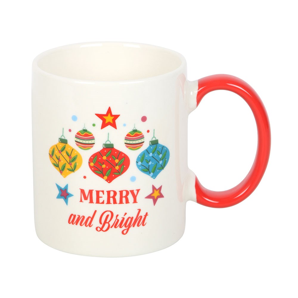 White mug with red handle featuring Christmas-themed design and 'Merry and Bright' text on a white background.