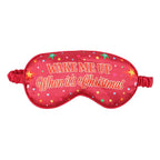 Red sleep mask with 'Wake Me Up When It's Christmas' text on a white background