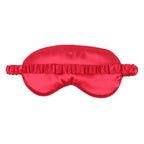 Red satin sleep mask on a white background