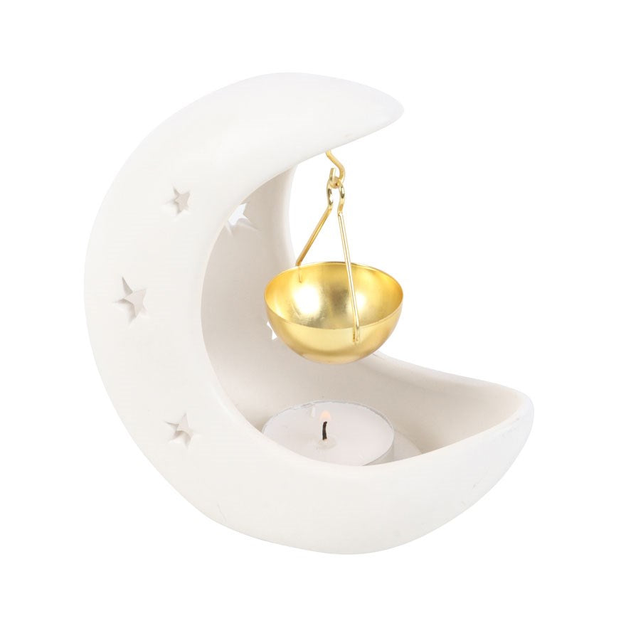 a white crescent moon shape oil burner and a gold bowl on a white background