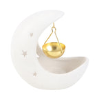 White ceramic crescent moon oil burner with gold hanging bowl on a white background