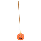 Pumpkin-shaped incense stick holder with a stick on a white background