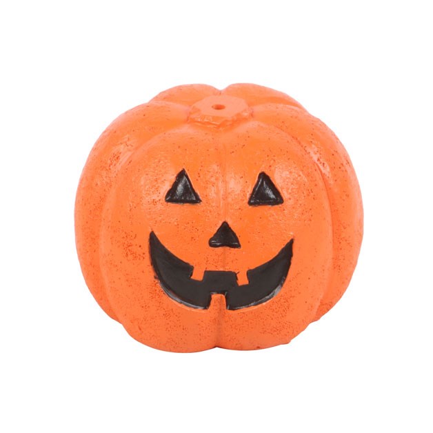 Orange pumpkin with black face incense stick holder on a white background