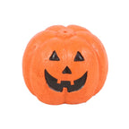 Orange pumpkin with black face incense stick holder on a white background