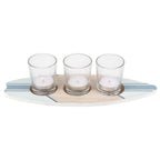 A surfboard-shaped wooden tealight holder with three clear glass holders for candles.