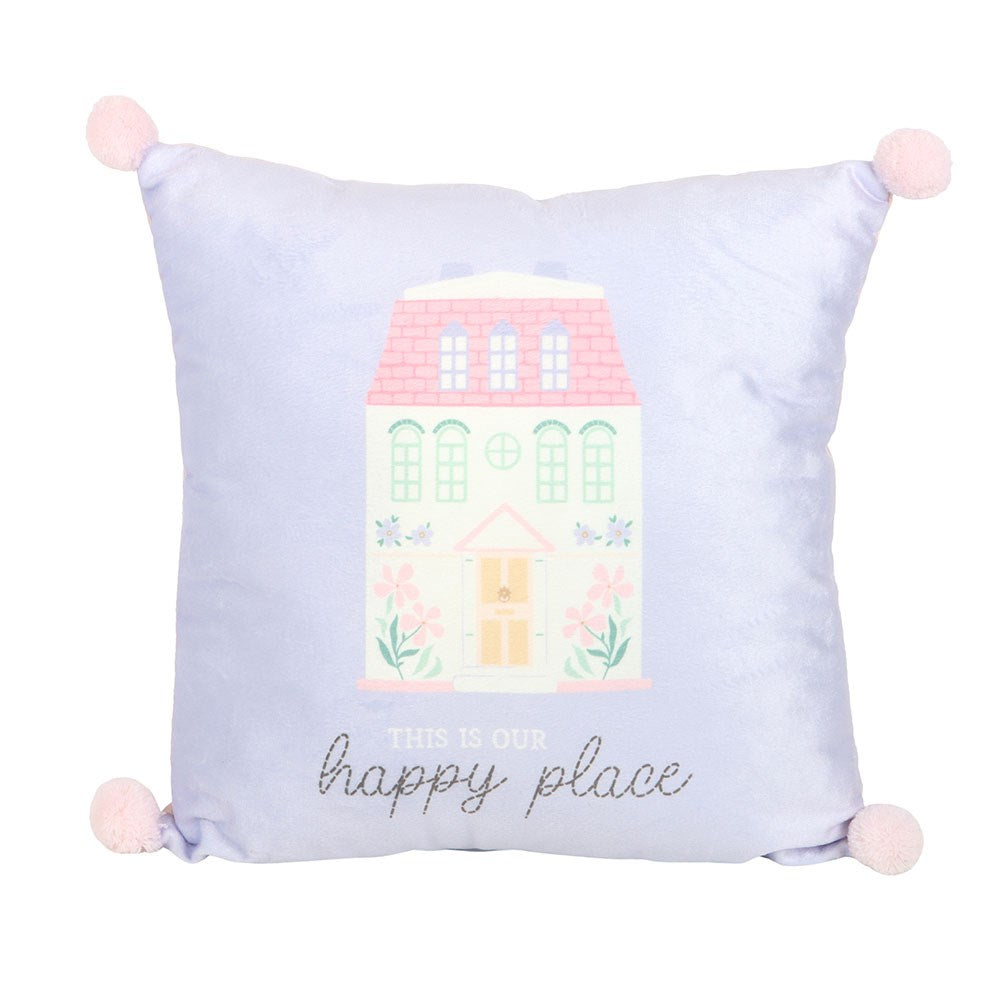 Decorative lilac cushion with a house illustration and 'This is our happy place' text on a white background