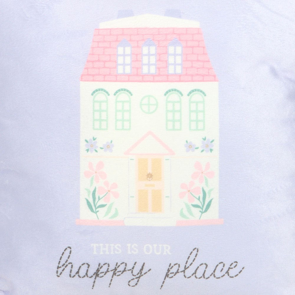 close up of cushion .Pastel coloured house illustration with 'This is our happy place' text on a light purple background